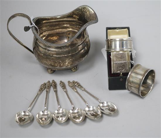 A George III silver cream jug, a Victorian silver napkin ring (cased), two other napkin rings and a set of six silver apostle spoons